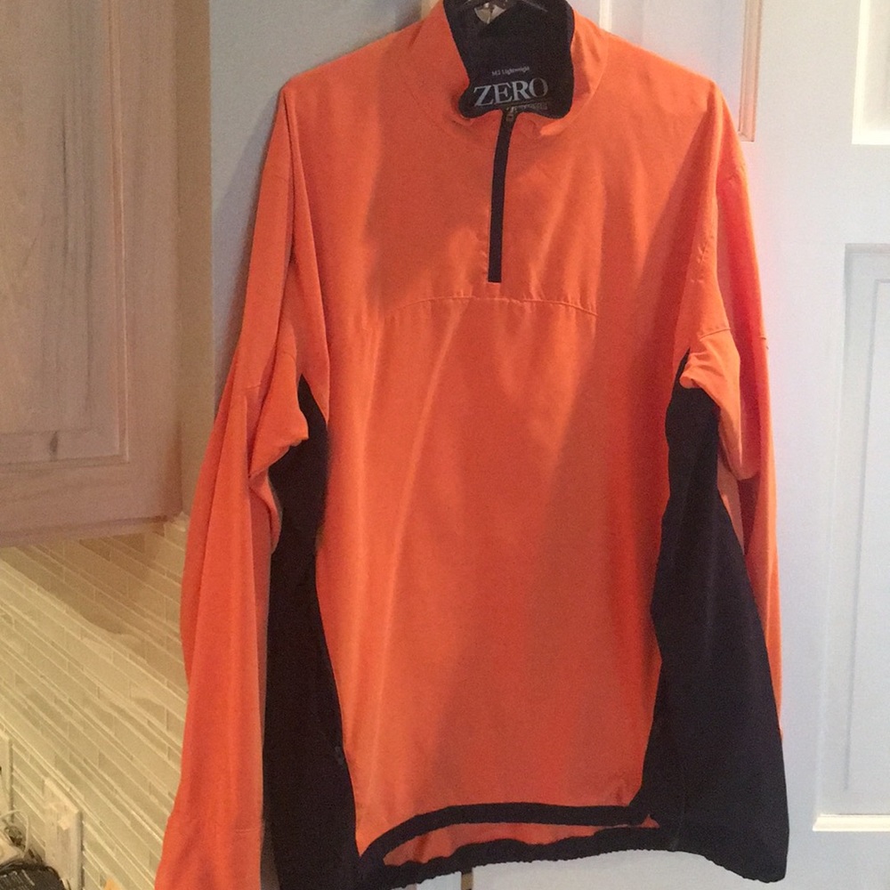 Zero Restriction orange/navy blue golf jacket.